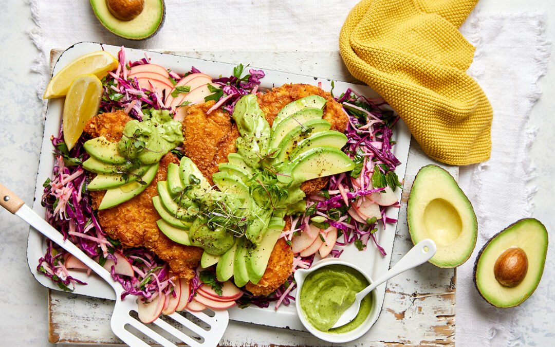 Cornflake crumbed chicken schnitzel with avocado, red cabbage slaw & a zesty avocado sauce